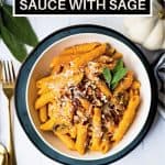 penne pasta with pumpkin pasta sauce in a white bowl