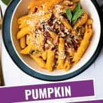 penne pasta with pumpkin pasta sauce in a white bowl