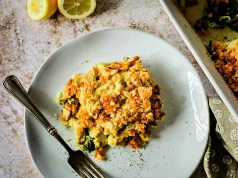 a serving of chicken curry broccoli casserole on a white plate with a fork