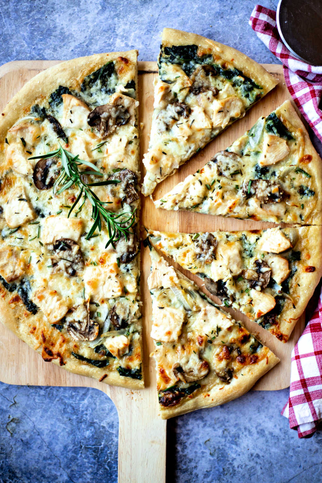 Florentine Chicken Pizza on a pizza peel