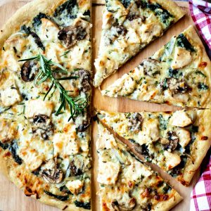 Florentine Chicken Pizza on a pizza peel