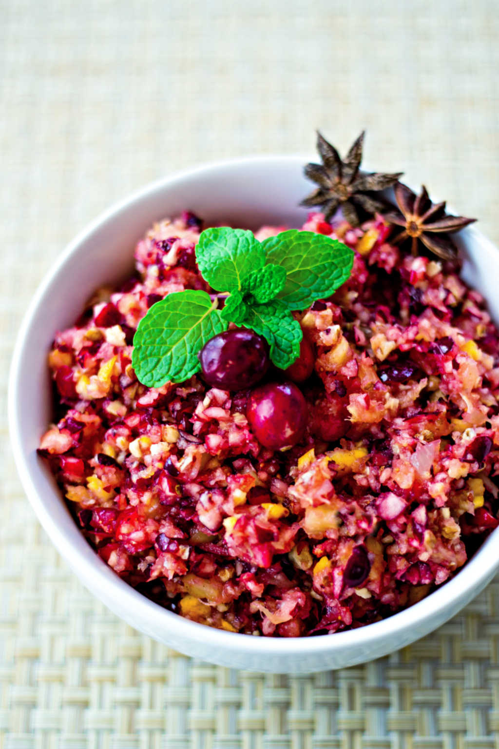 cranberry relish in a white bowl garnished with fresh mint
