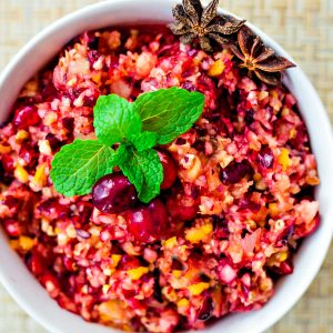cranberry relish in a white bowl garnished with fresh mint
