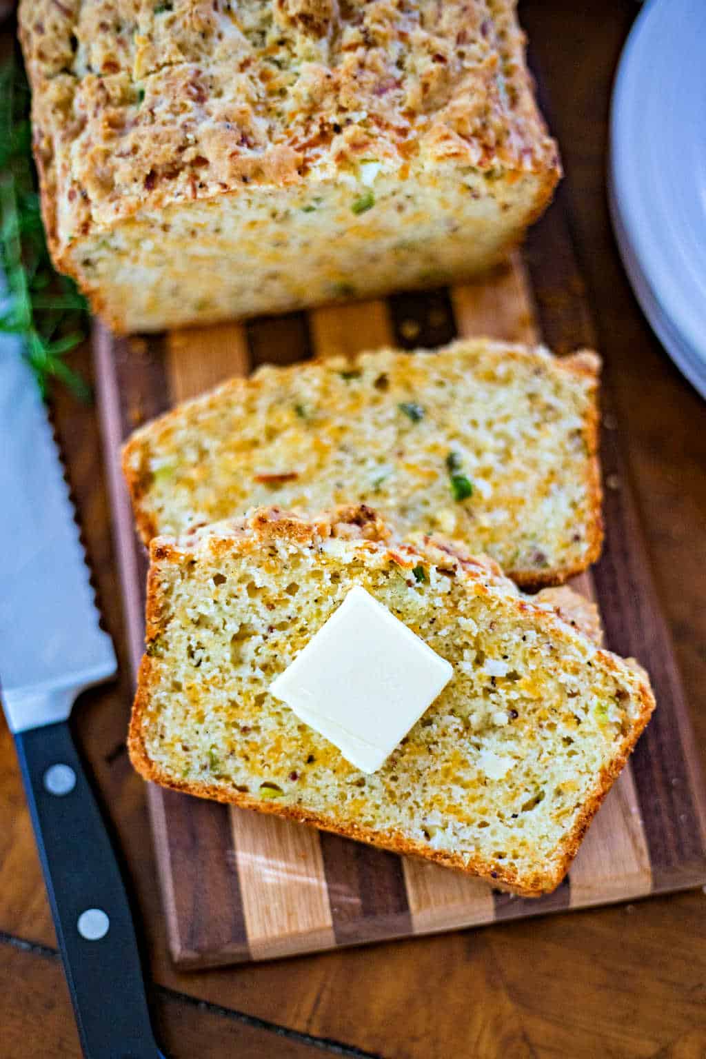 cheese bread loaf slices on a wooden board