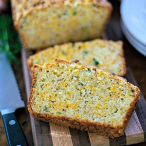 cheese bread loaf slices on a wooden board