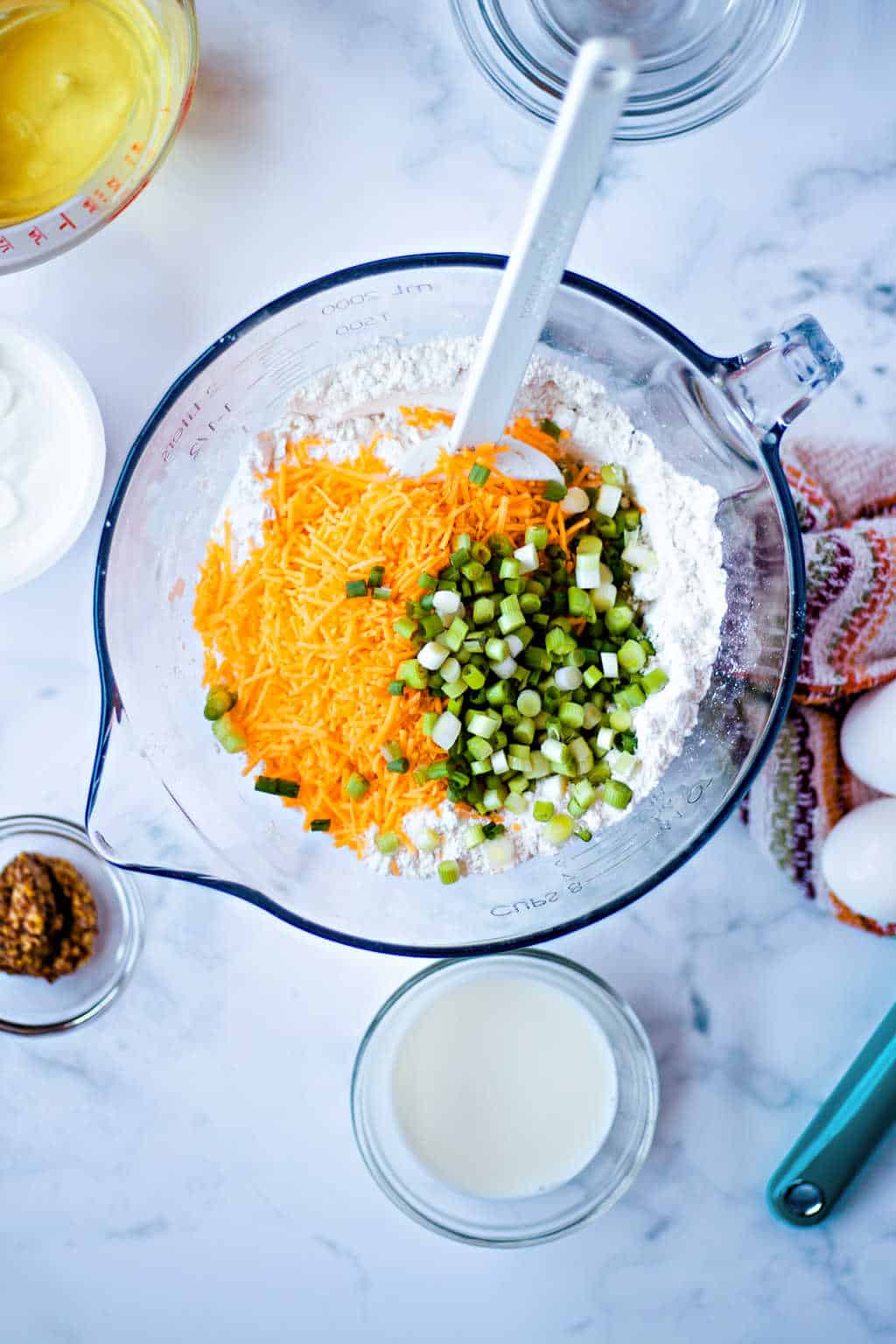 making batter for cheese bread in a glass bowl