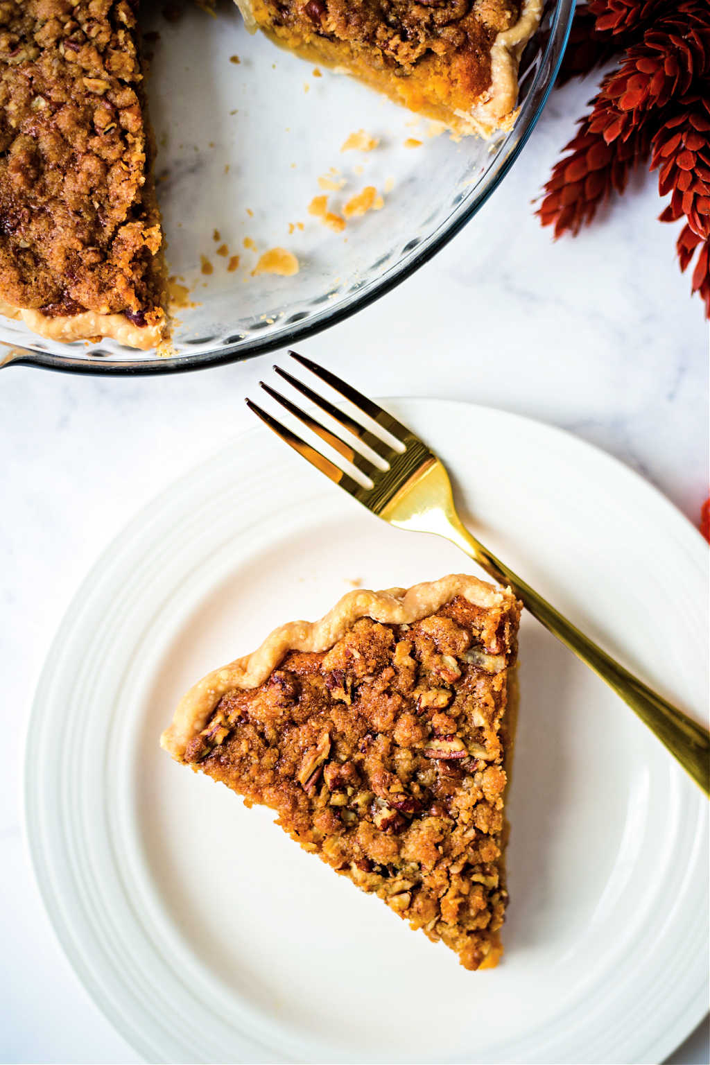 a slice of sweet potato pie on a white plate on a table