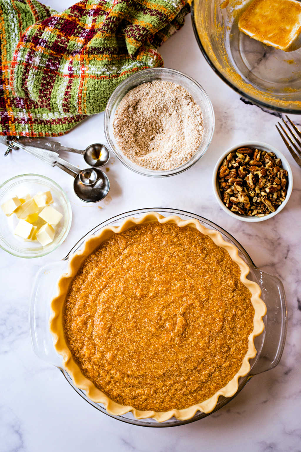 unbaked sweet potato pie on a table ready for the oven