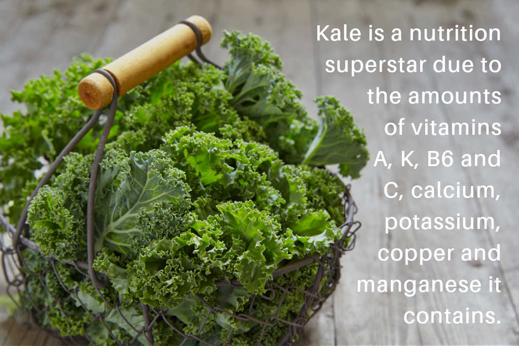 a basket of fresh kale on a wooden table