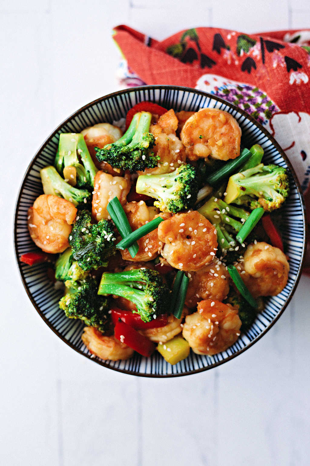 shrimp broccoli stir fry in a bowl on a table