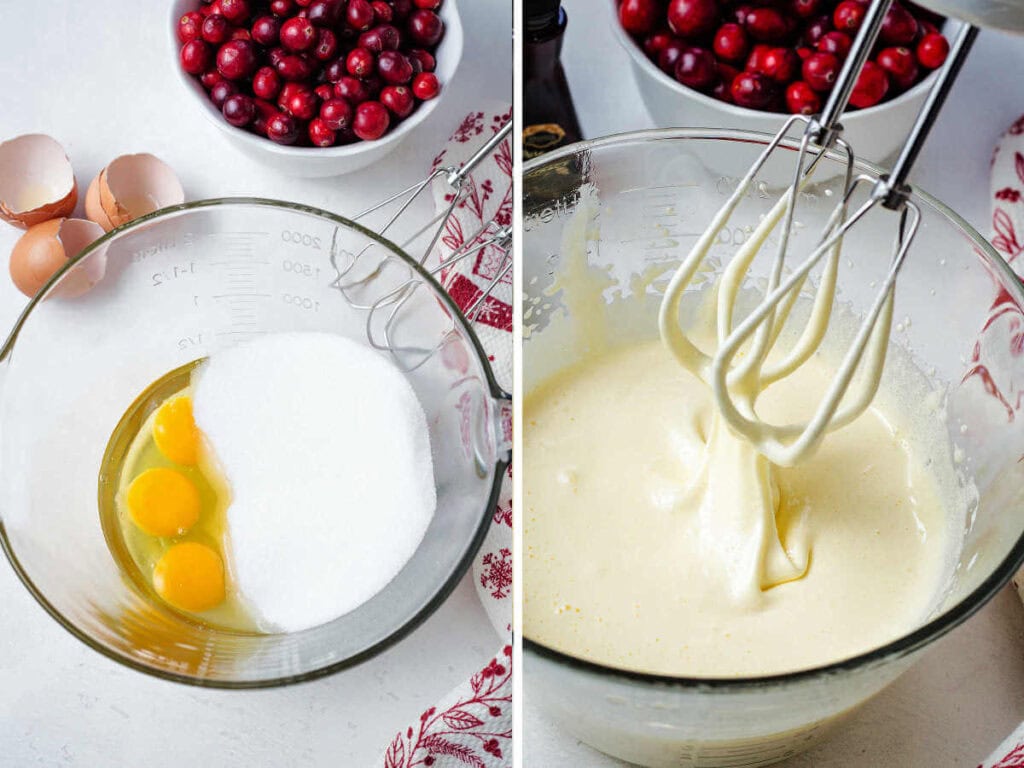 Eggs and sugar in a mixing owl with the beaters of an electric mixer and cranberries on the table.