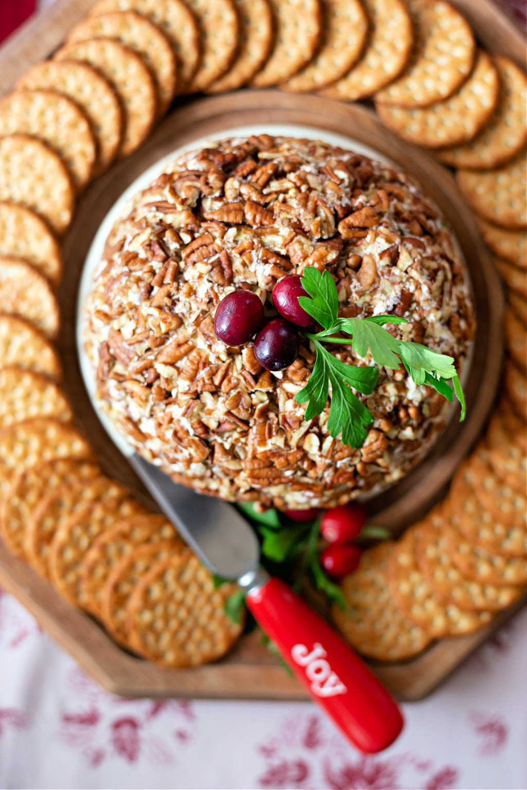 pineapple cheese ball on a tray with crackers