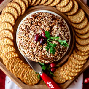 pineapple cheese ball on a tray with crackers