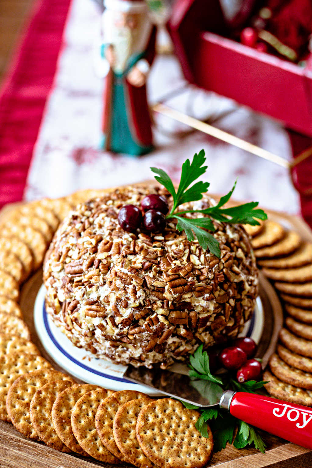 pineapple cheese ball on a tray with crackers