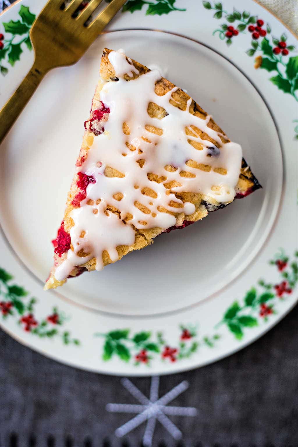 a slice of cranberry cake on Christmas china plate