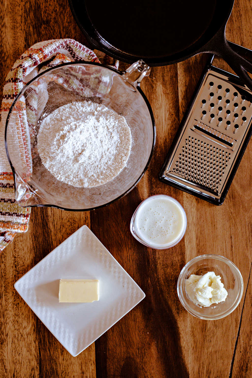 ingredients for biscuit bread in an iron skillet