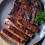coffee rubbed steak sliced on a gray plate