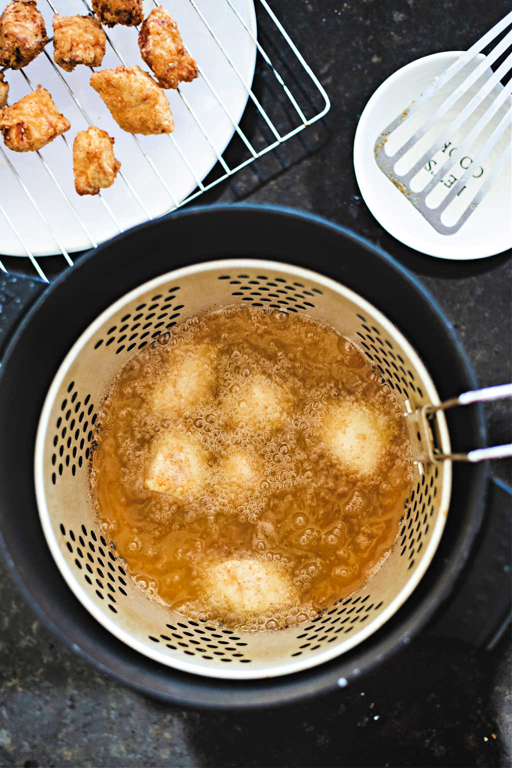 Chick-fil-A Chicken Nuggets frying in hot oil.