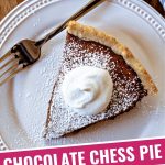 a slice of chocolate chess pie on a white plate on a wooden table.