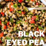 Black Eyed Pea Salad in a white bowl with a spoon.