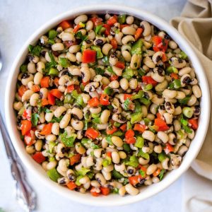 black eyed pea salad in a white bowl on a table.