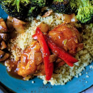 catalina chicken with couscous and broccoli on a blue plate