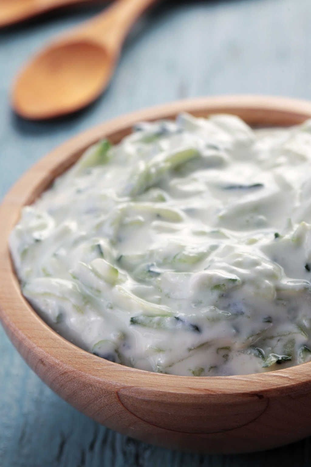 a bowl of tzatziki sauce on a table.