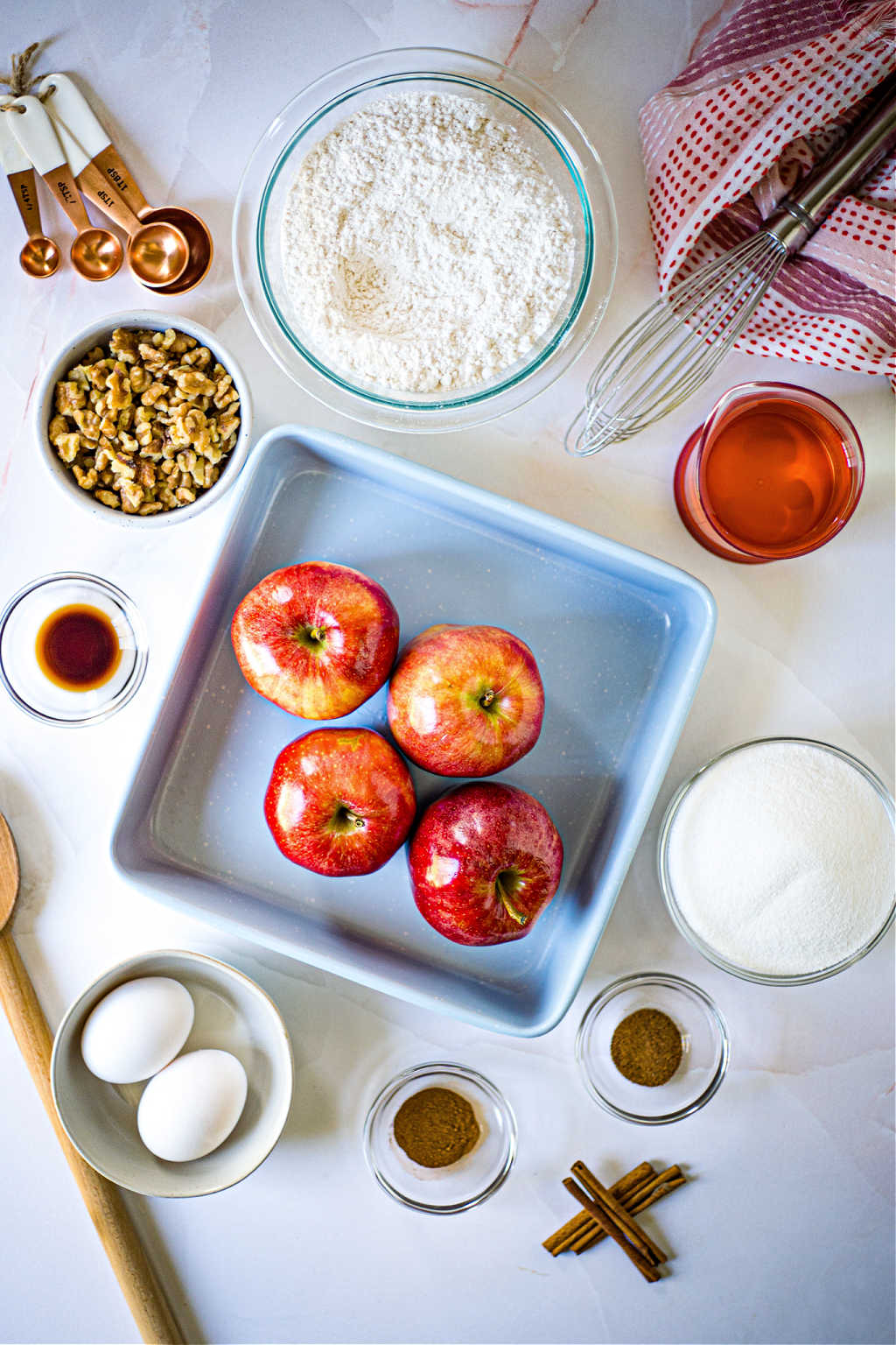 ingredients for apple walnut cake on a table.