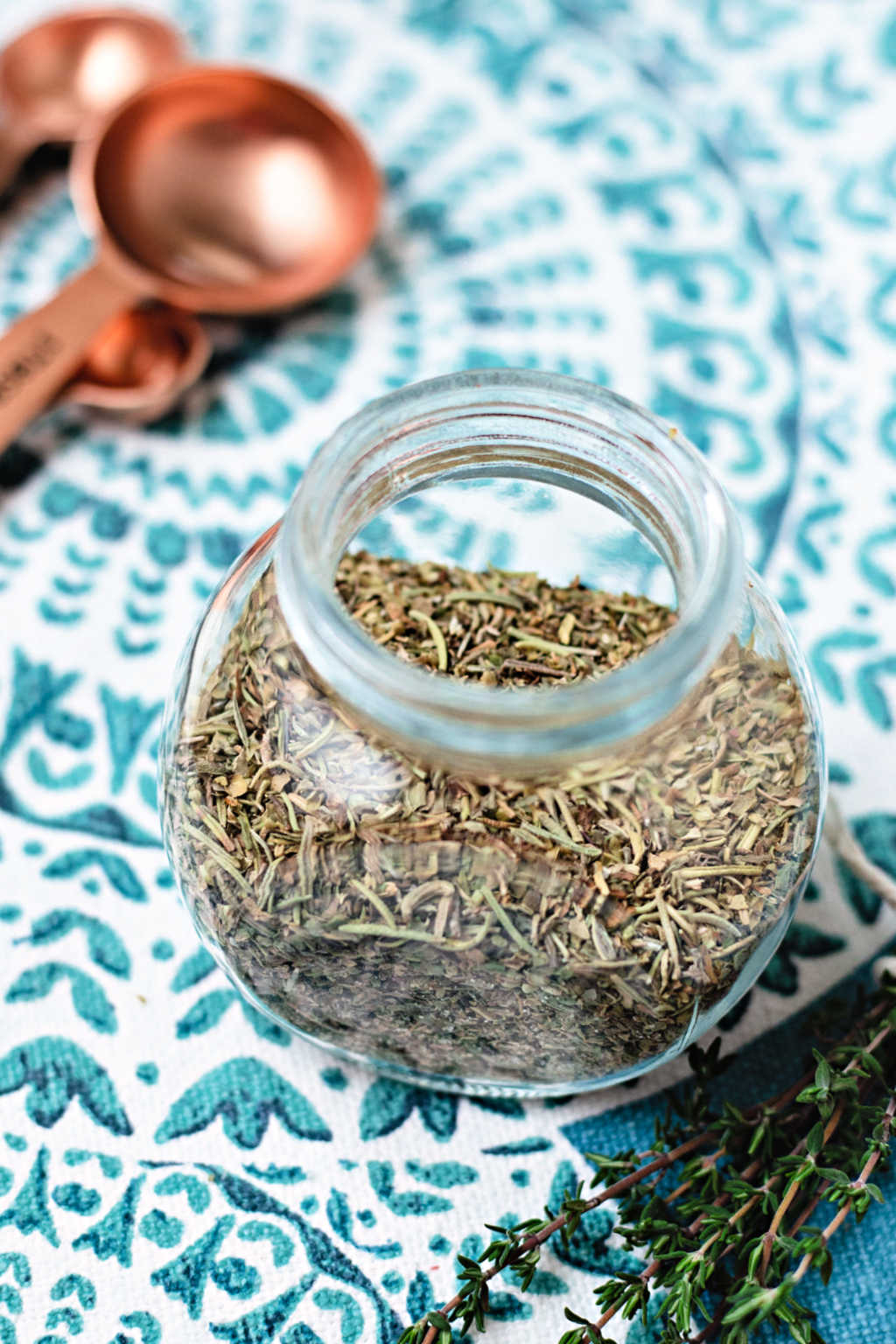 italian seasoning substitute in a glass jar on a placemat.