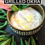 Grilled Okra on a black platter with a bowl of dipping sauce.
