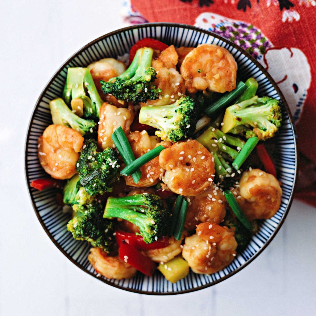 Shrimp and broccoli stir fry in a bowl over rice.