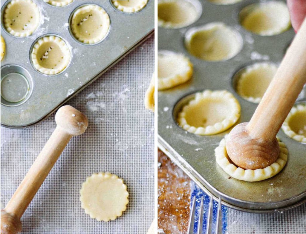 pressing tart dough into mini muffin tins with a wooden shaper.