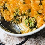 SOUTHERN BROCCOLI CHEESE RICE CASSEROLE IN A WHITE DISH.