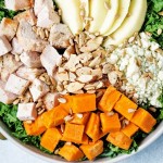 harvest chicken salad in a bowl drizzled with balsamic vinaigrette.