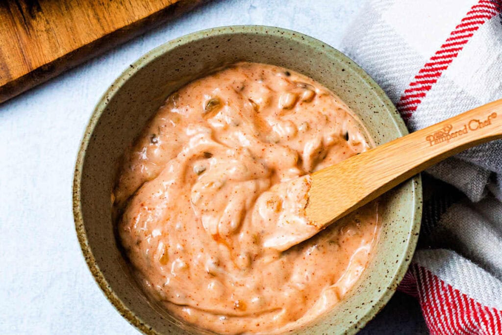 A bowl of thousand island dressing on a table.
