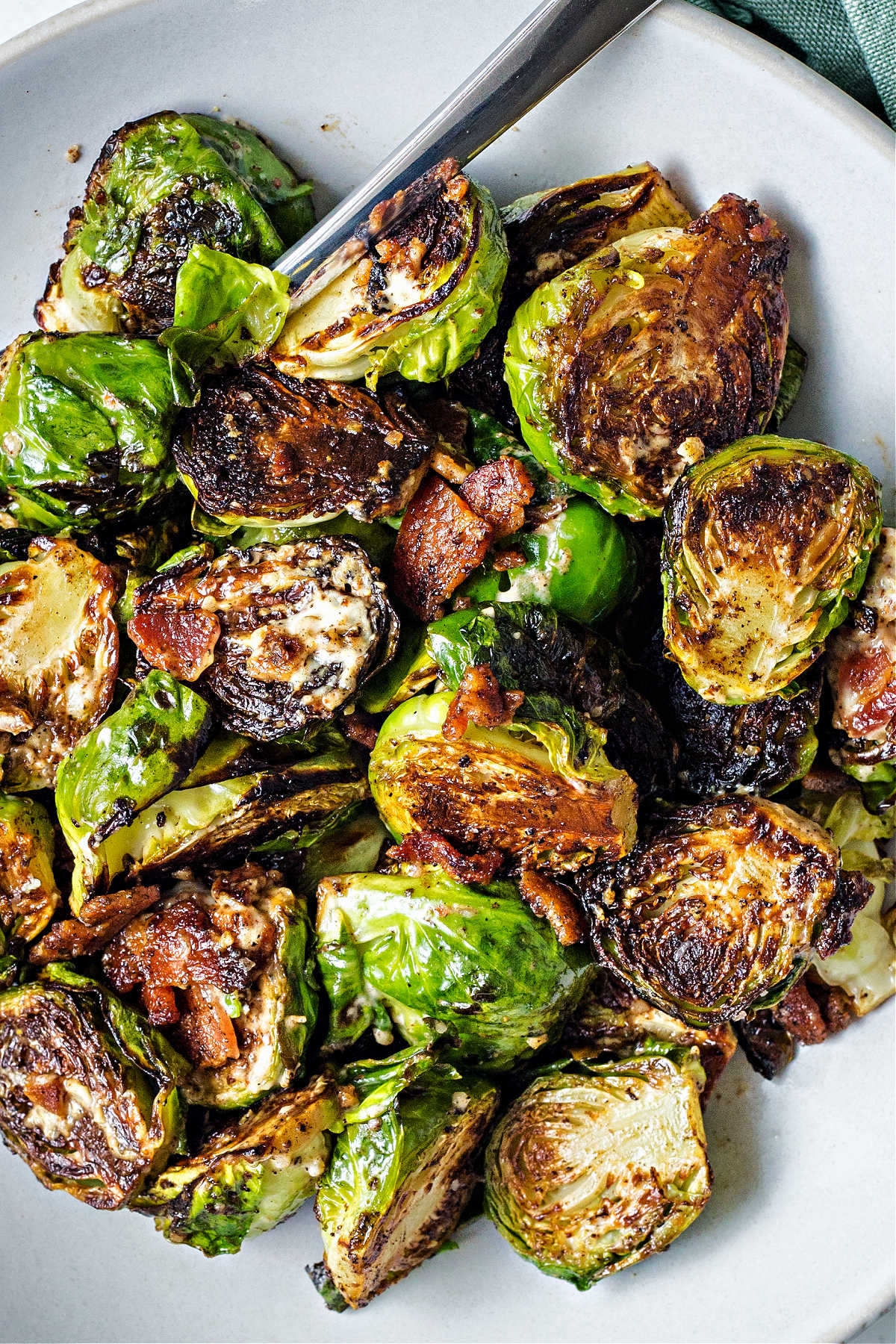 close up view of caramelized brussels sprouts with bits of bacon.