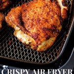 a cooked, crispy chicken thigh lying in the basket of an air fryer.