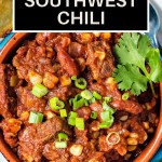 a bowl of slow cooker southwest chili garnished with green onions and cilantro with a corn muffin on a plate.