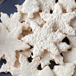 vanilla cookies in star shapes stacked on a plate onto a table.