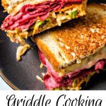 a corned beef reuben with coleslaw sandwich cut in half and stacked on a plate.