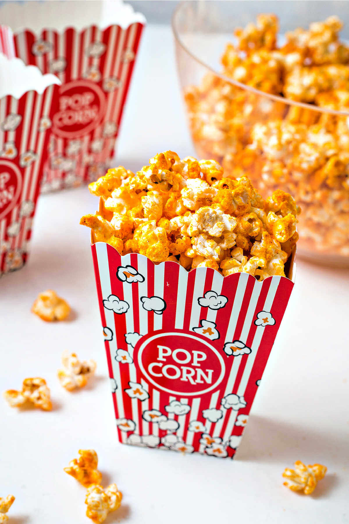 cheddar cheese popcorn in a red and white striped popcorn box.