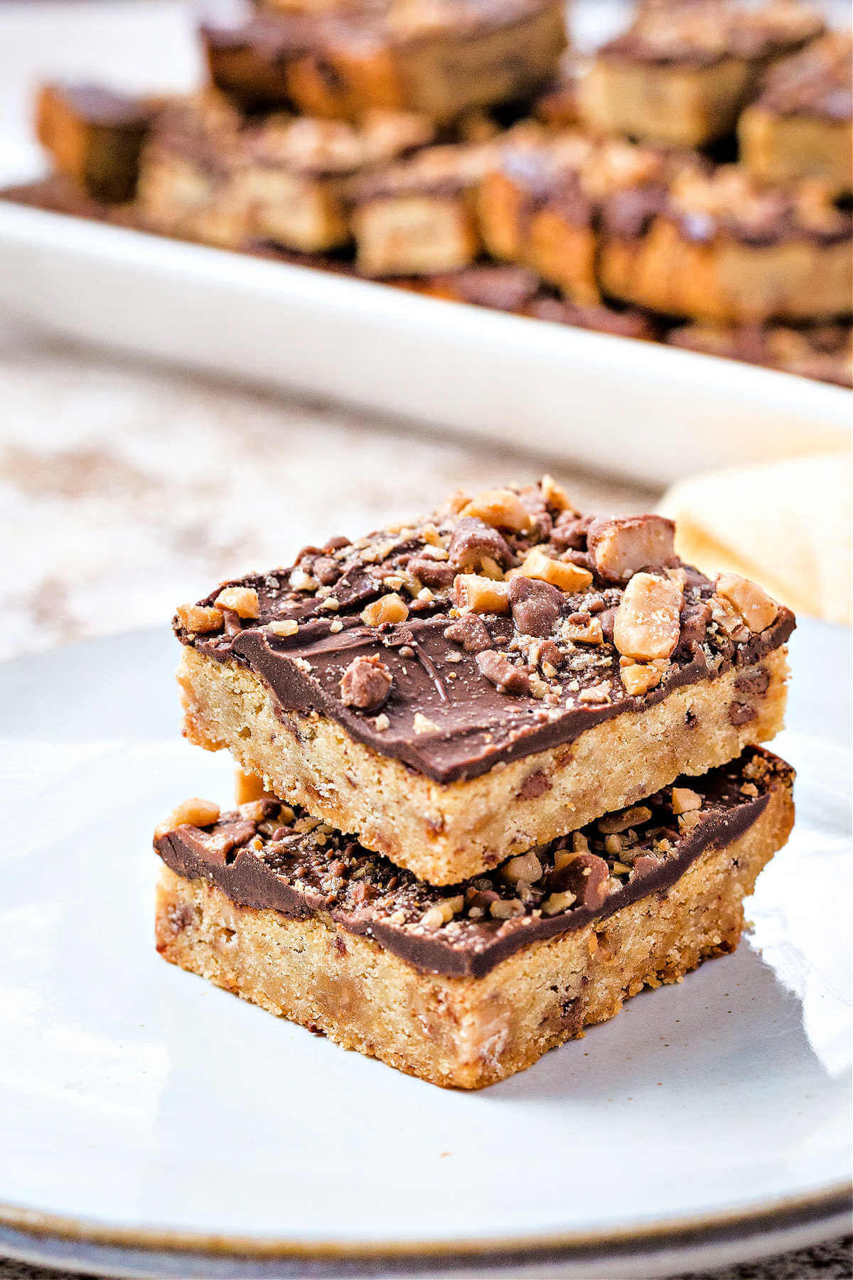 two Heath cookie bars stacked on top of each other on a plate.