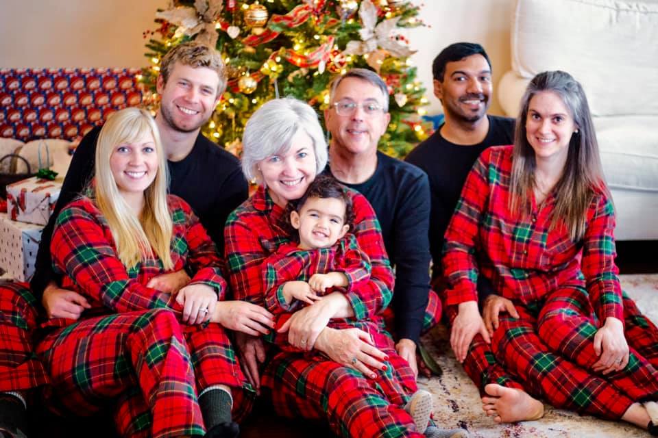 a family in matching Christmas pajamas.