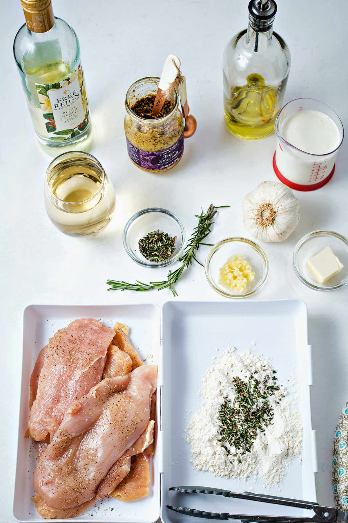 ingredients for making chicken dijon on a table.