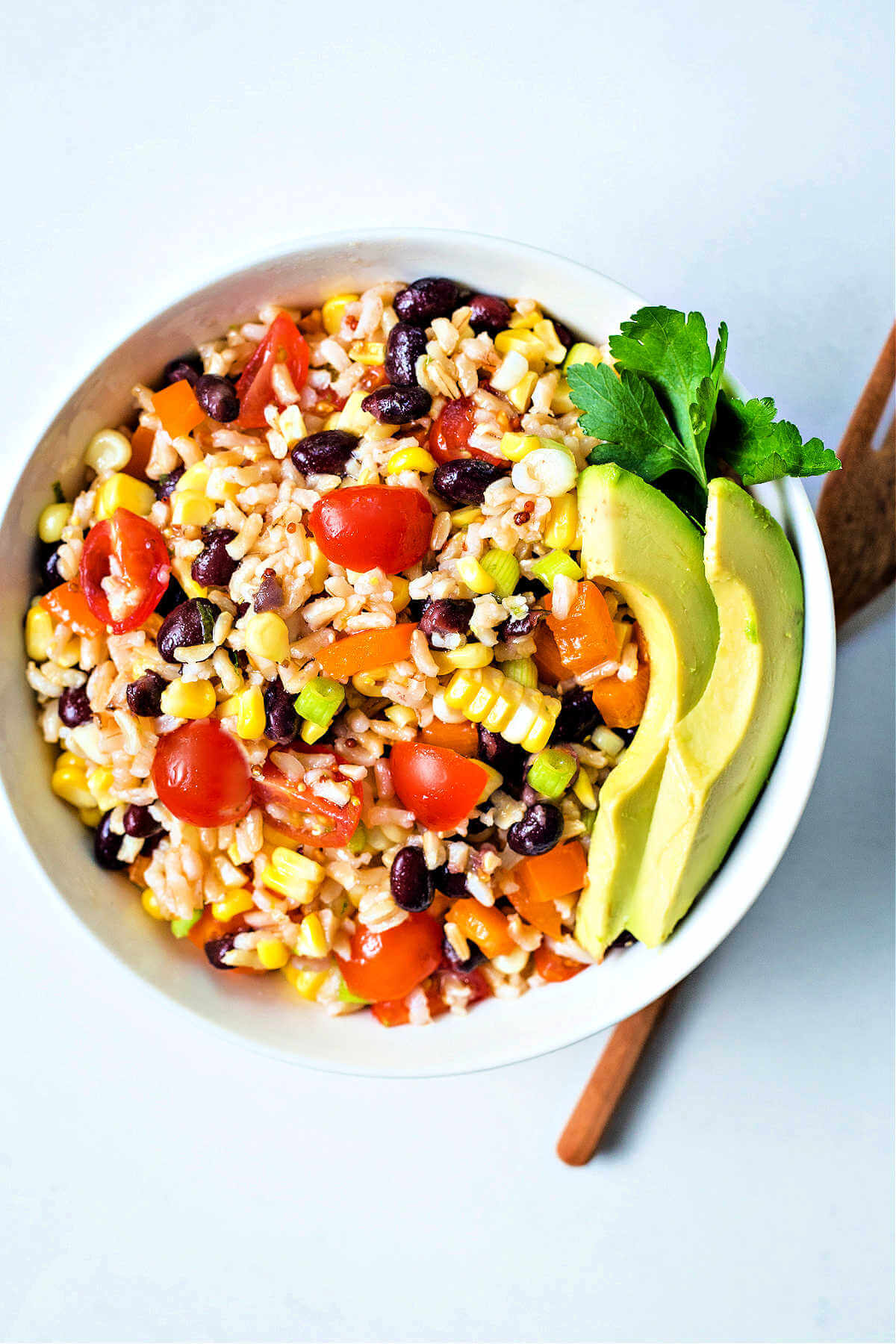 Santa Fe rice salad in a bowl with slices of avocado.