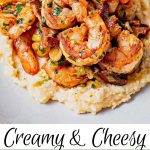 shrimp ladled on top of a bed of stone ground cheese grits with a lemon wedge and parsley.