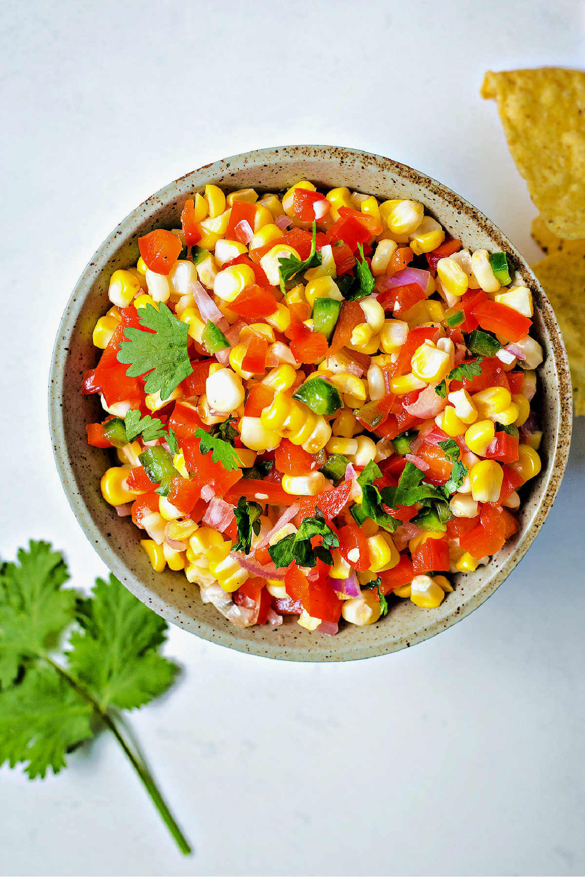 corn salsa iin a serving bowl garnished with cilantro.