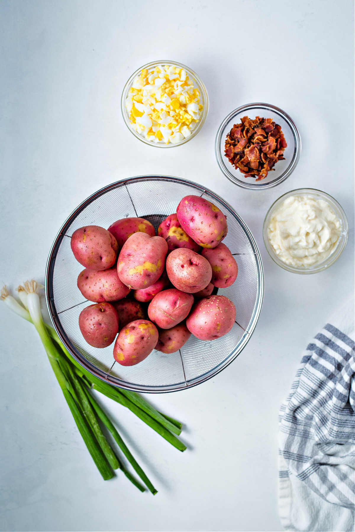 ingredients for red potato salad on a table.