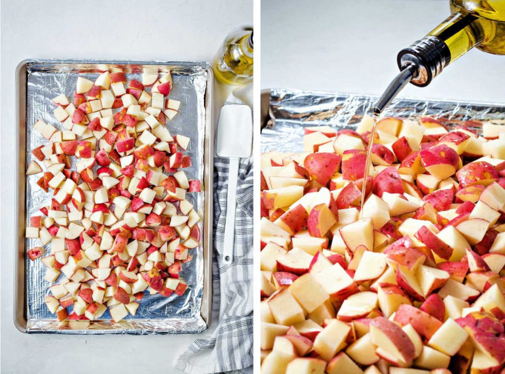 preparing to roast potatoes on an aluminum foil lined pan by drizzling with olive oil.