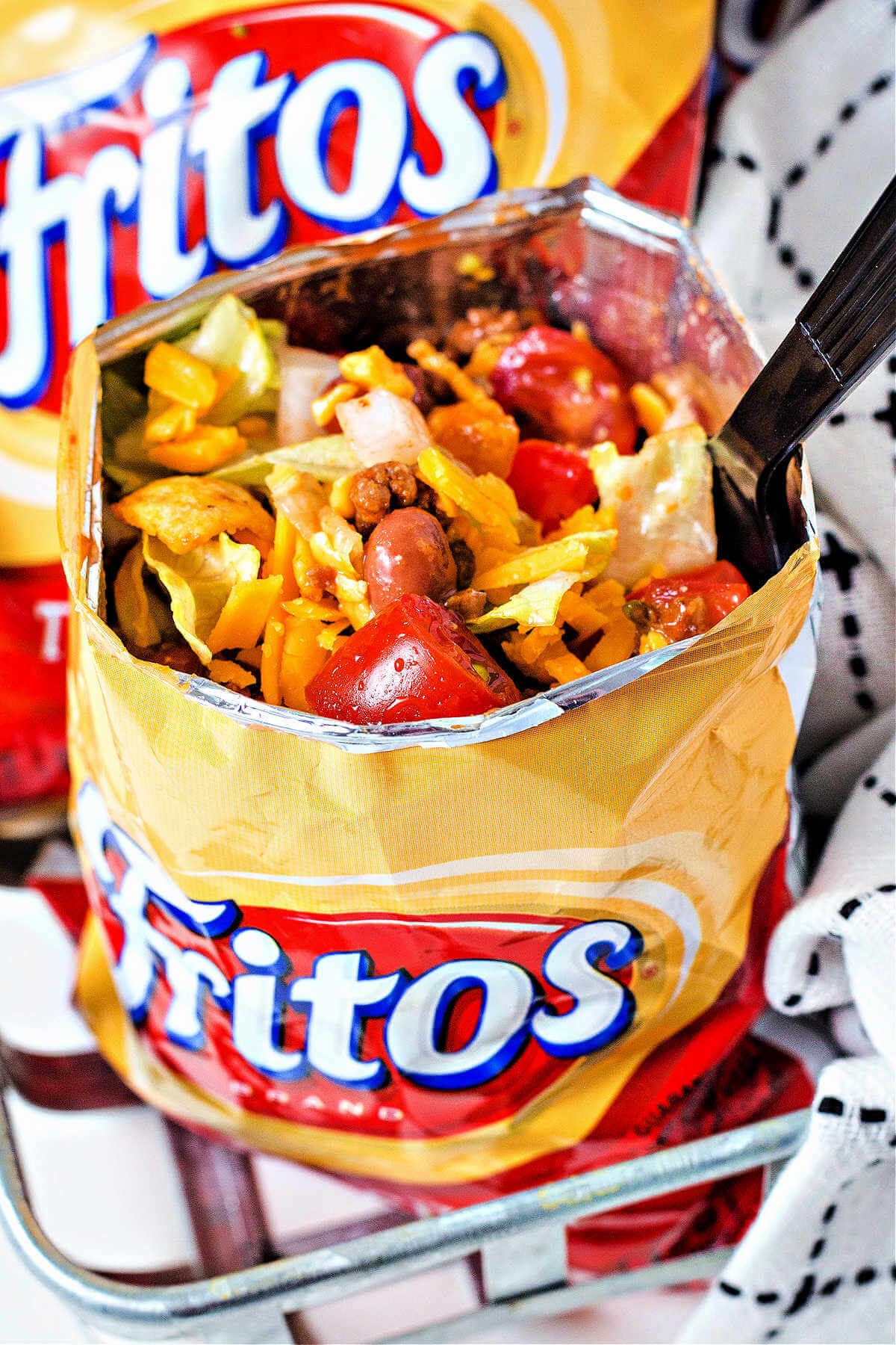 catalina taco salad served in a individual size Fritos bag with a plastic fork.